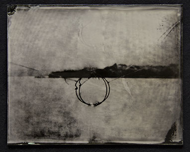 Landscape becomes abstract field of bright silver /w moire pattern. Dark fine gestures form a circle @ctr intersected by broad stroke of horizon