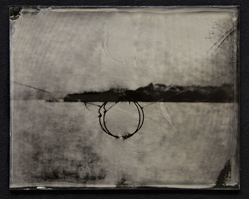 Landscape becomes abstract field of bright silver /w moire pattern. Dark fine gestures form a circle @ctr intersected by broad stroke of horizon