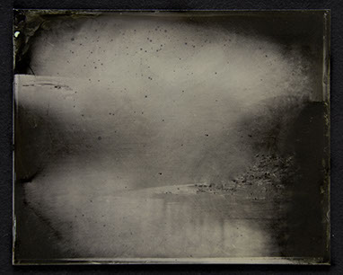 Panel C1: Landscape photo on glass. Silvery greys emerge from blacks to form passages of hard surfaces & insubstantial gases peppered /w black.