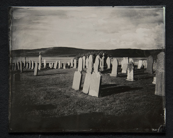 Panel B3 depicts a landscape full of tall, thin gravestones. Three in the foreground glow white from the sun. Rolling hills crown the distance.