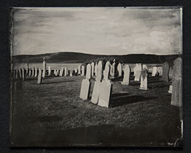 Panel B3 depicts a landscape full of tall, thin gravestones. Three in the foreground glow white from the sun. Rolling hills crown the distance.